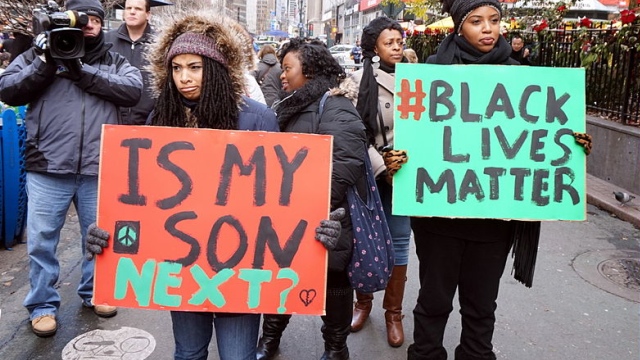 Protestors carrying placards at a Black Lives Matter demonstration in New York City in 2014 (All-Nite Images / Wikimedia)