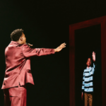 Claude reaching for his younger self on stage at Eurovision 2025 (EBU / Alma Bengtsson)