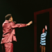 Claude reaching for his younger self on stage at Eurovision 2025 (EBU / Alma Bengtsson)